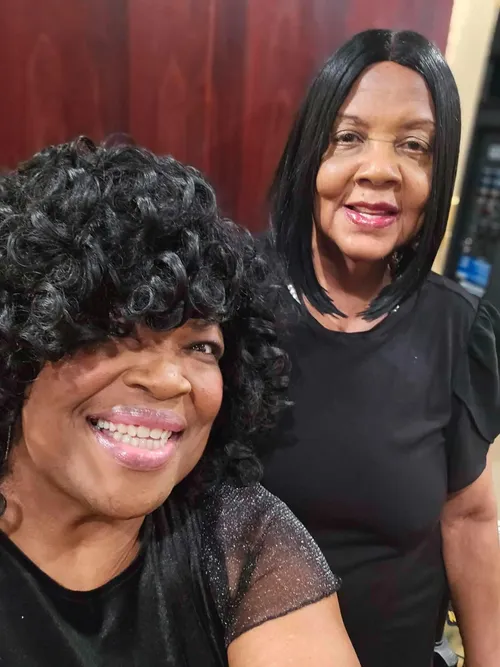 Two guests sharing a smile backstage at the arts exhibition