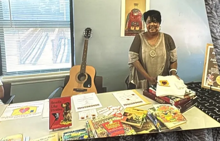 Founder Shernavian Roper Vandiber setting up books and activities for a program day